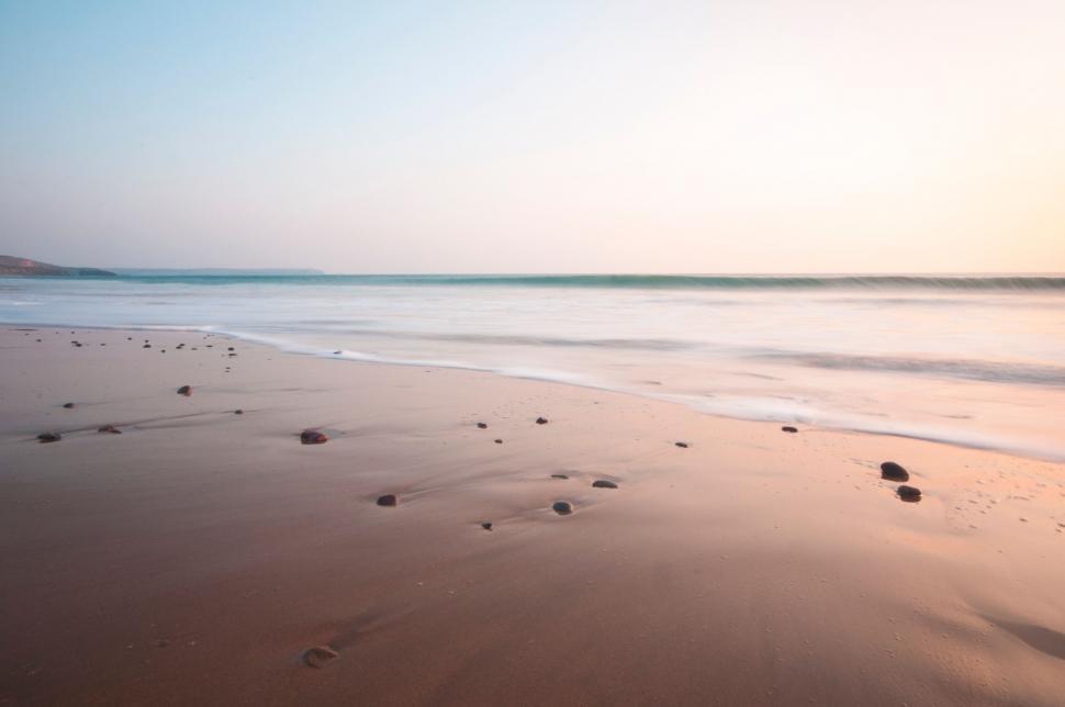Free Image of Sandy Beach With Footprints in the Sand 