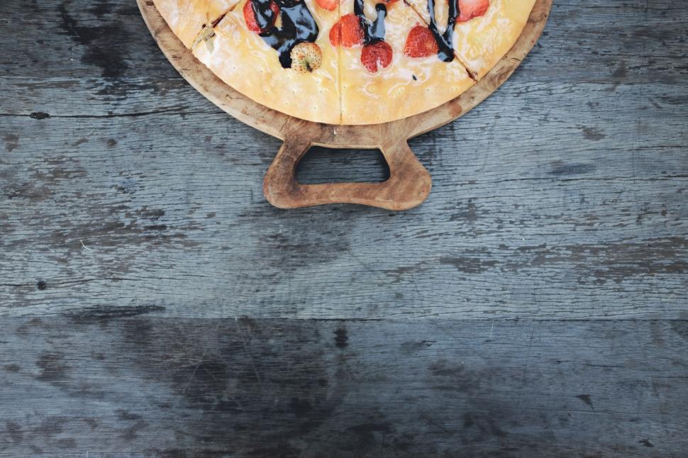 Free Image of Pizza on Wooden Cutting Board 