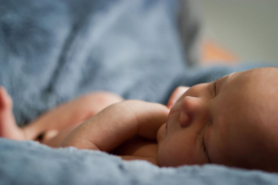 Free Image of Baby Sleeping on Blue Blanket 