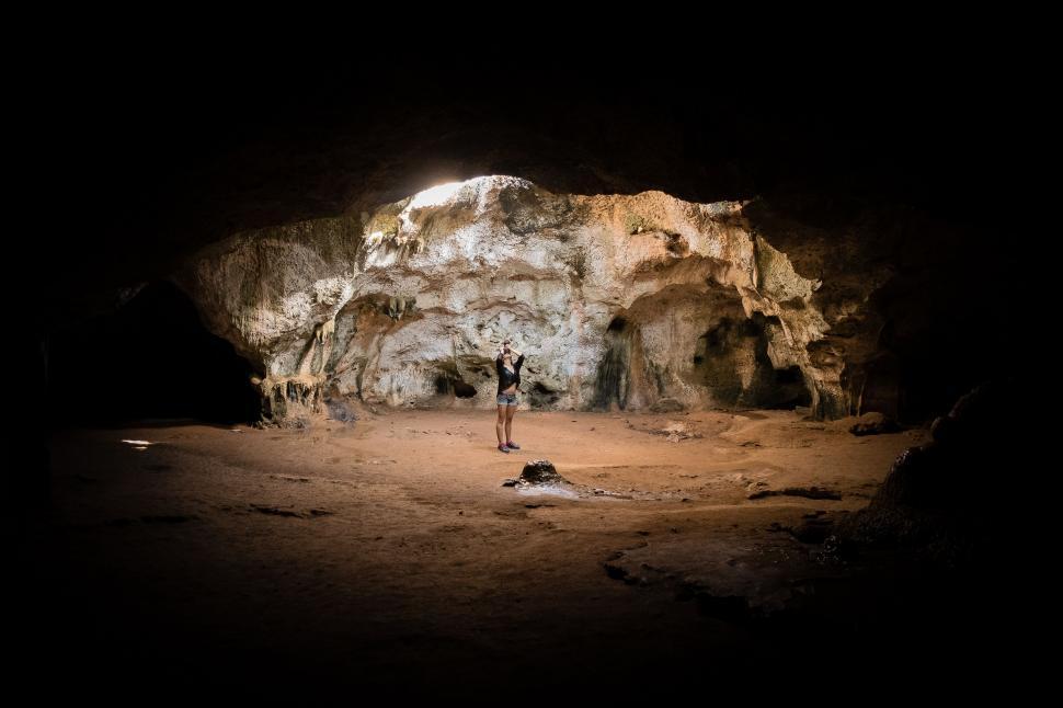 Free Image of Man Standing in the Middle of a Cave 