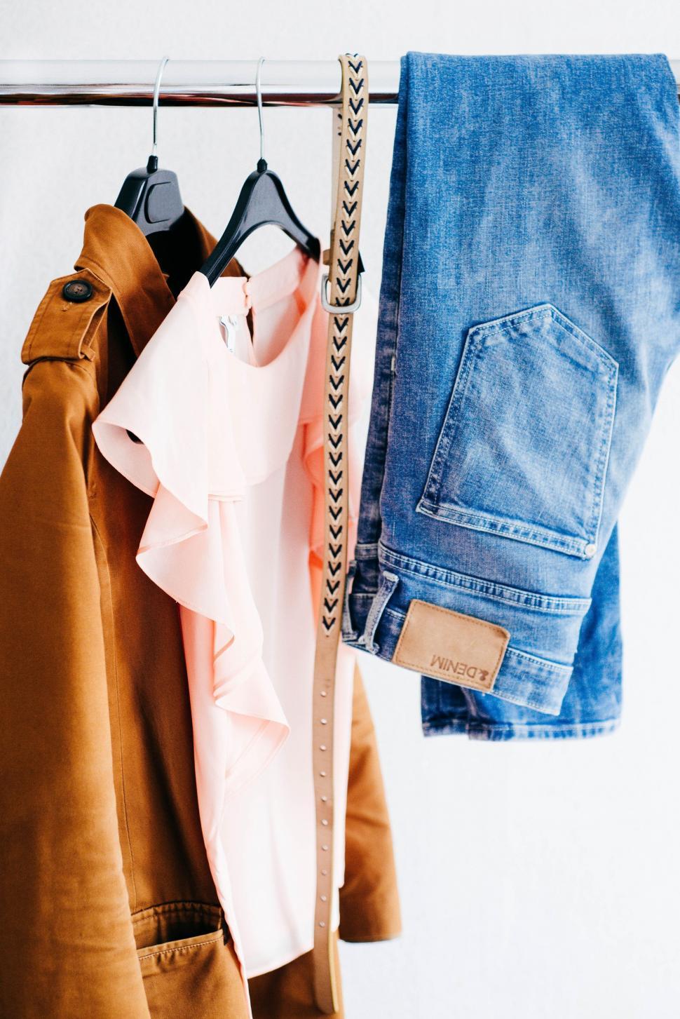 Free Image of Pair of Jeans Hanging on Clothes Rack 