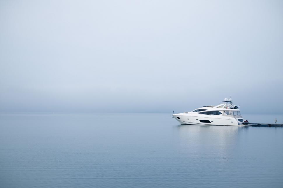 Free Image of White Boat Floating on Large Body of Water 
