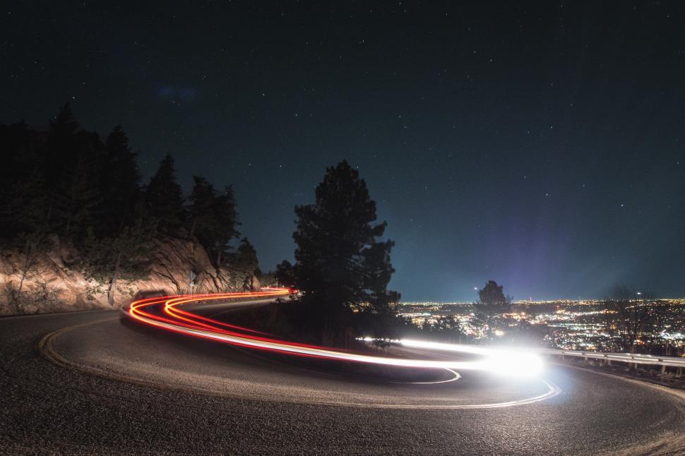 Free Image of Car Driving Down Road at Night 