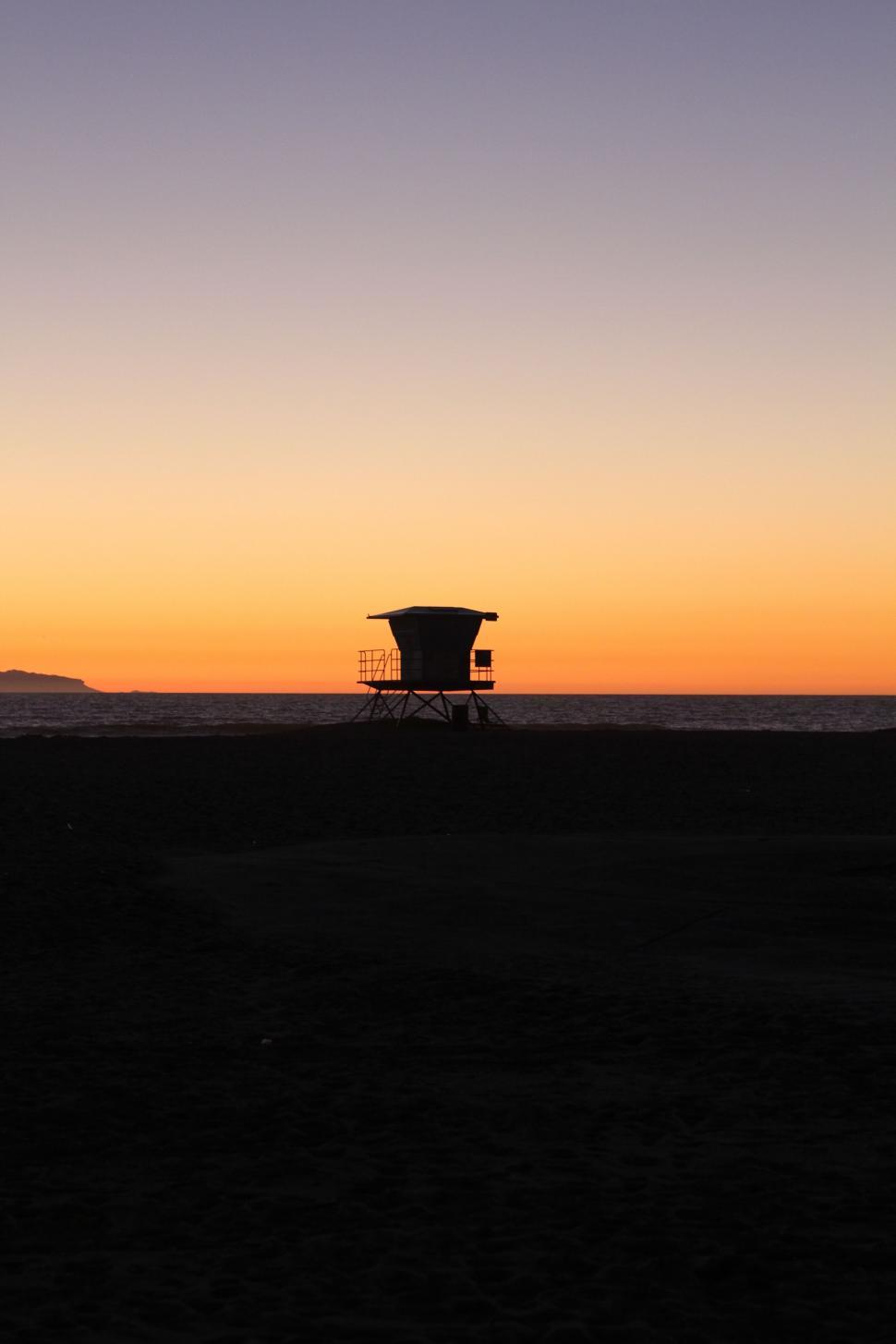 Free Image of Silo Standing in Field at Sunset 
