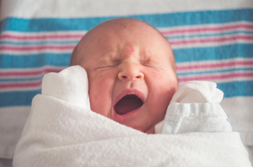 Free Image of Baby With Mouth Open in a Blanket 