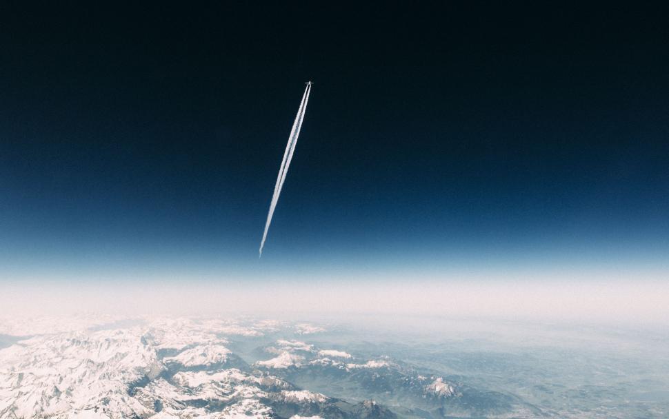 Free Image of Airplane Flying Over Mountain Range 