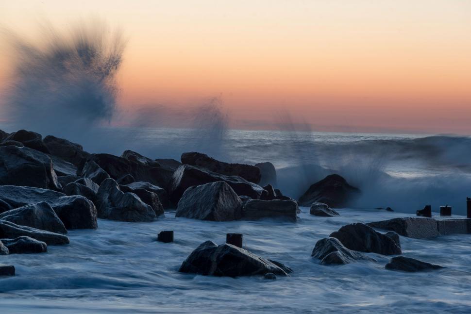 Free Image of Large Wave Crashing Over Rocks in the Ocean 
