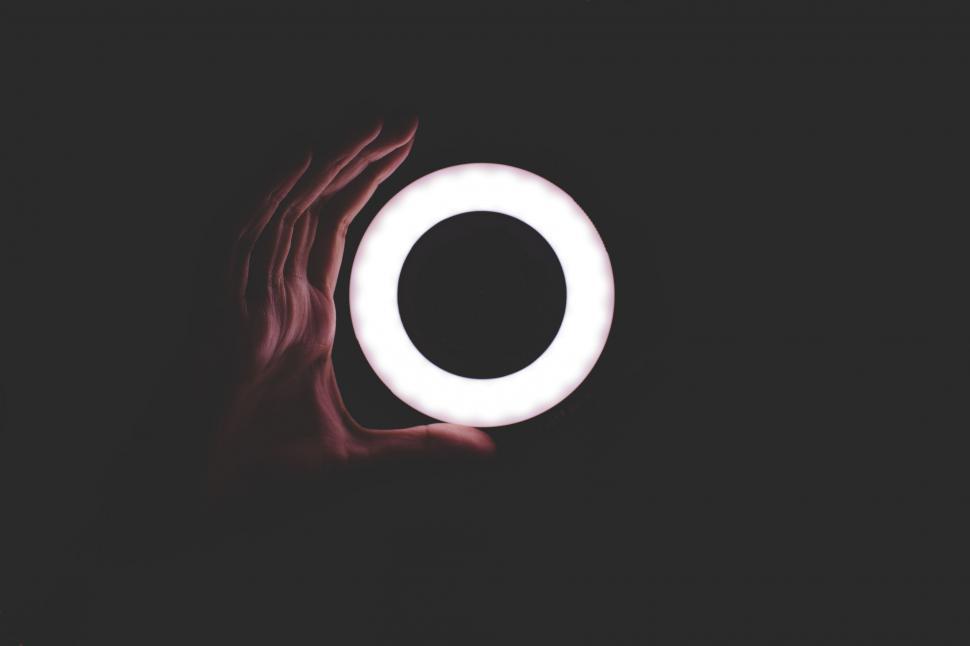 Free Image of Person Holding a Light Up in the Dark 