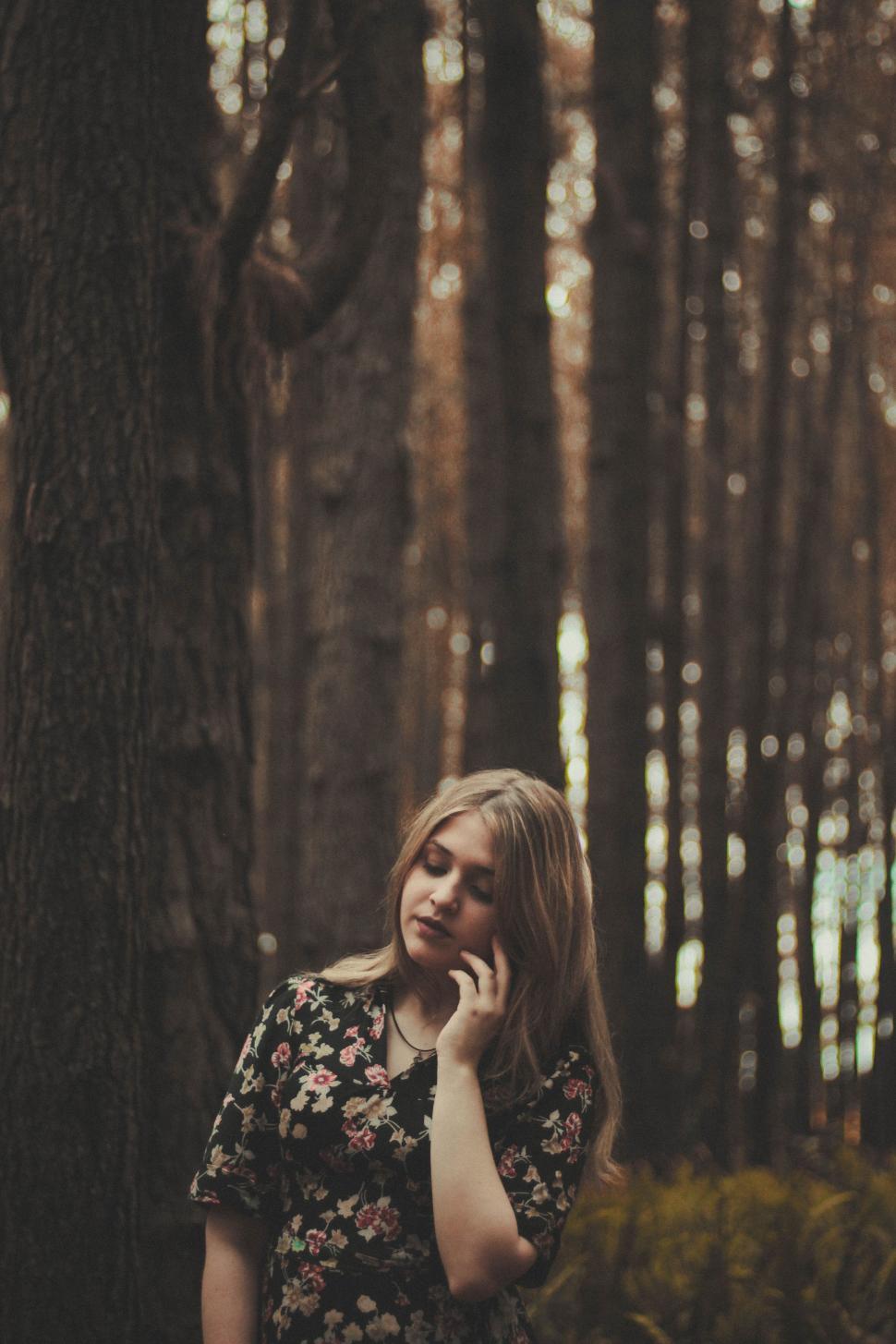Free Image of Woman Standing in Forest Talking on Cell Phone 