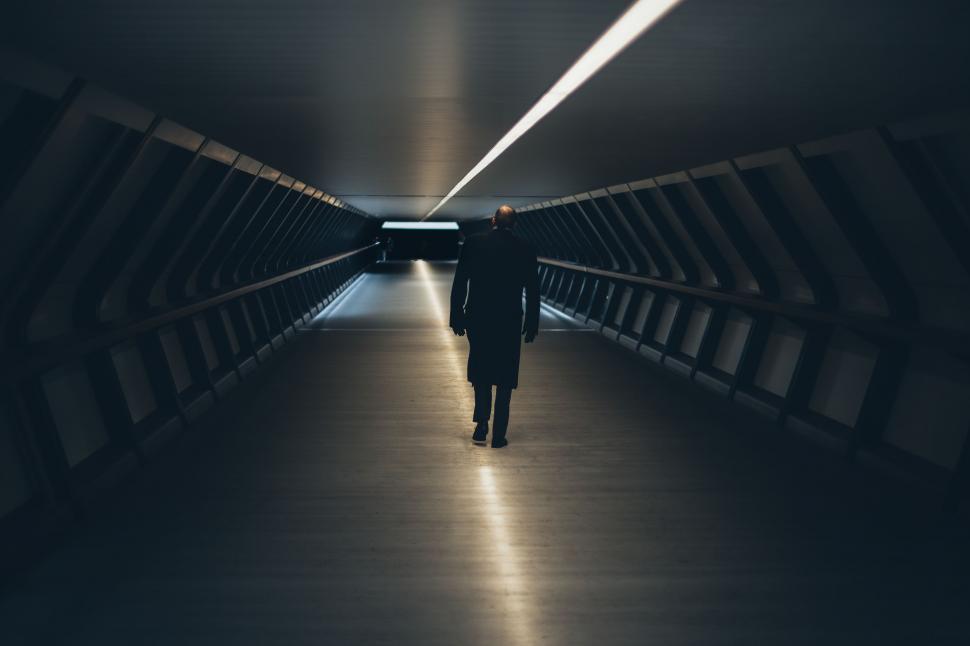 Free Image of Person Walking Down a Dark Tunnel 