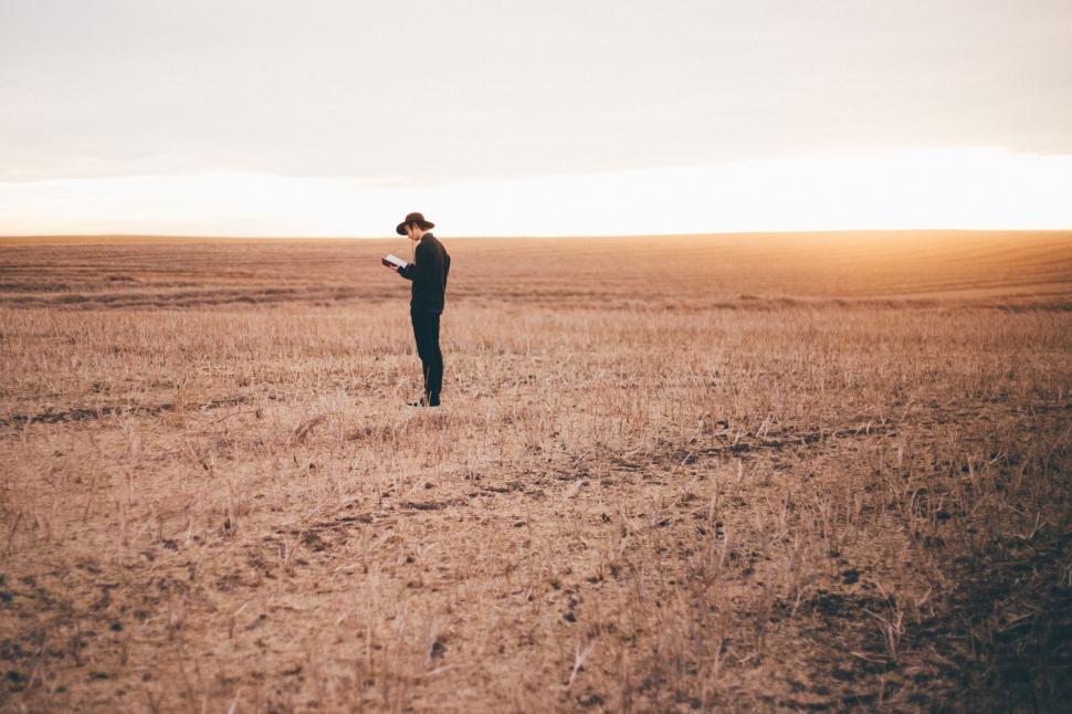 Free Image of Person Standing in Field With Hat On 
