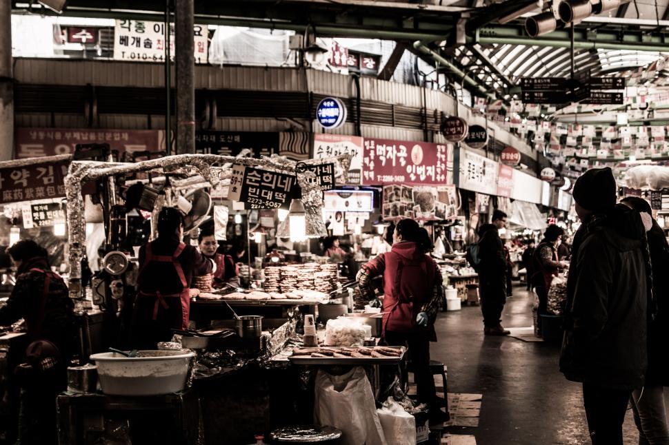 Free Image of Group of People Walking Around a Market 