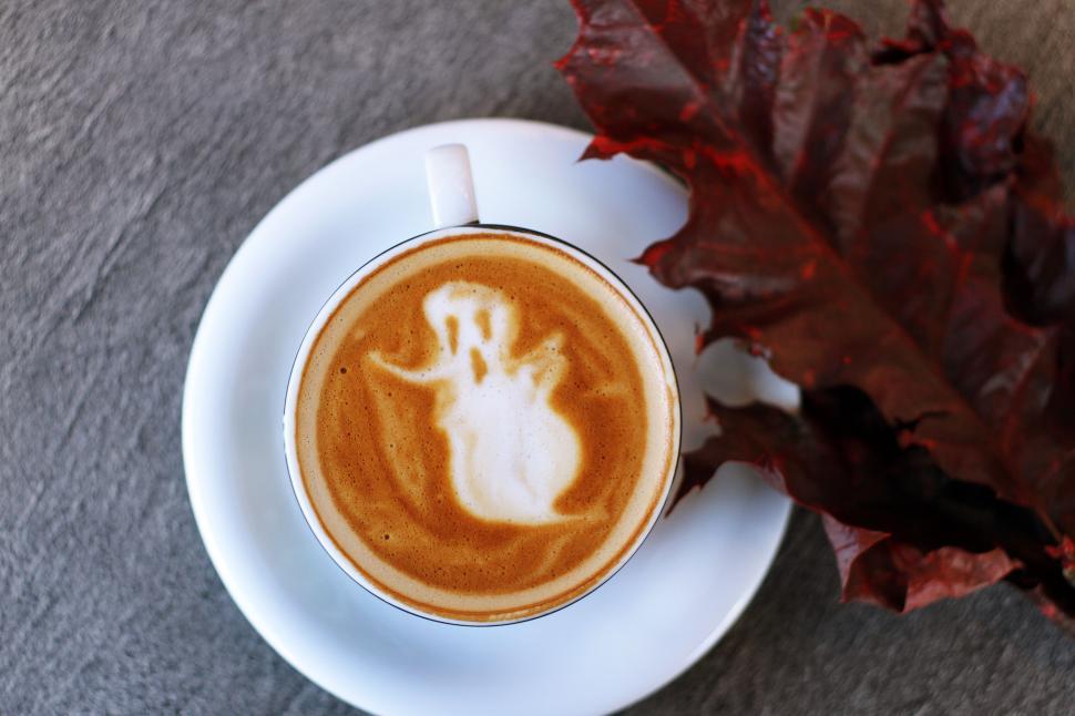 Free Image of A Cup of Coffee With a Ghost Drawn on It 