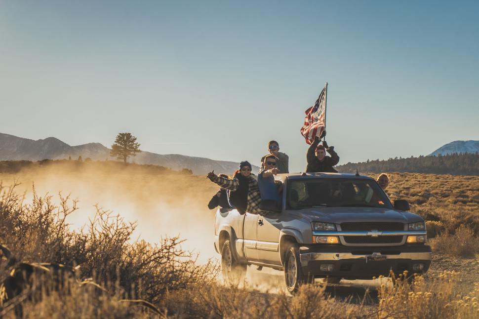 Free Image of Group of People Riding in the Back of a Pick Up Truck 