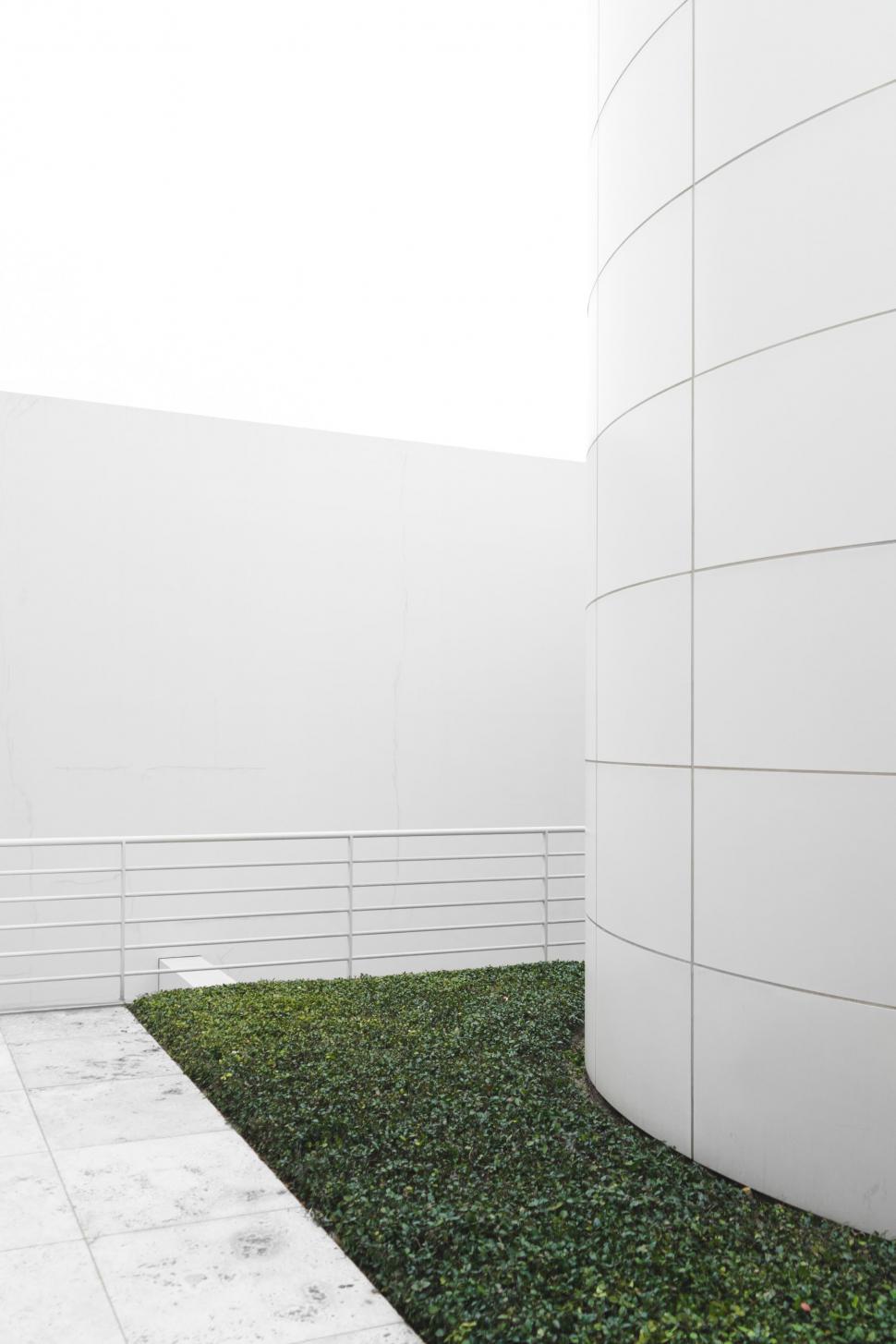 Free Image of White Building With Green Carpet 
