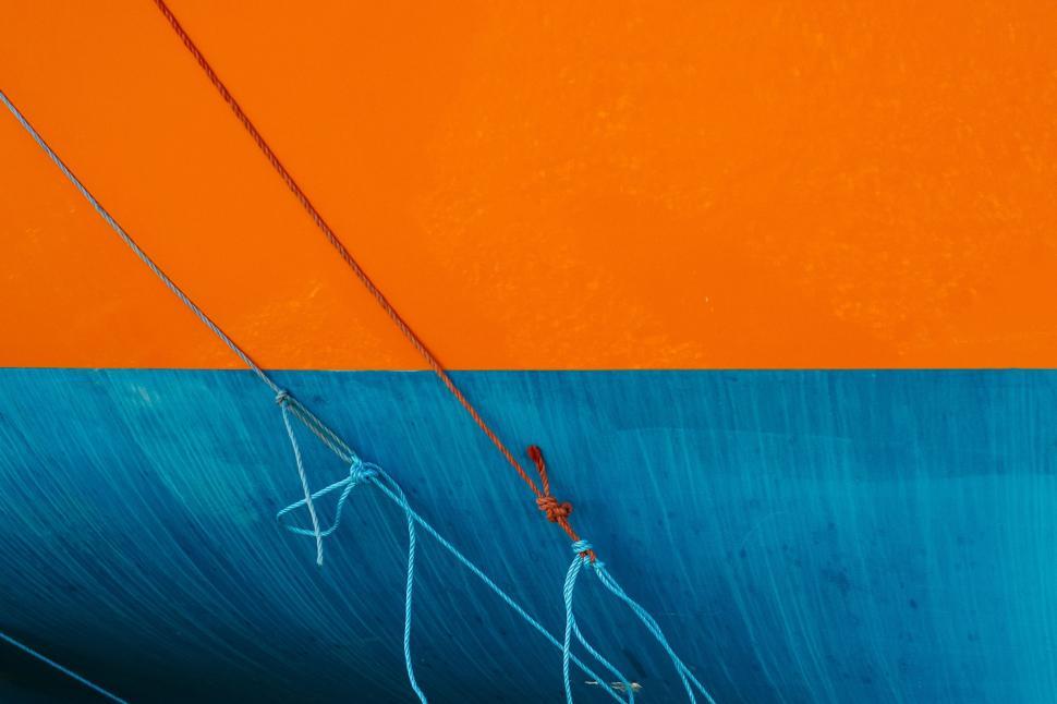 Free Image of Orange and Blue Painting of a Boat in the Water 
