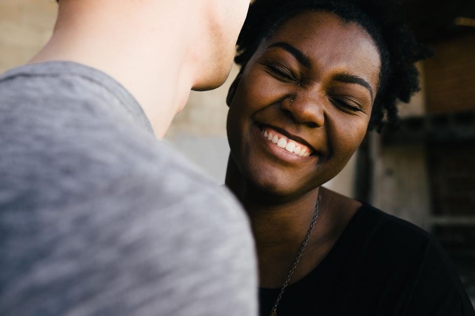 Free Image of Woman Smiles as Man Looks at Her 