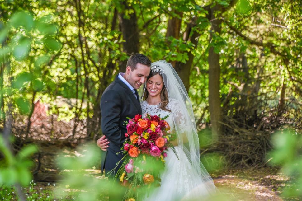 Free Image of Bride and Groom Posing for Wedding Picture in the Woods 