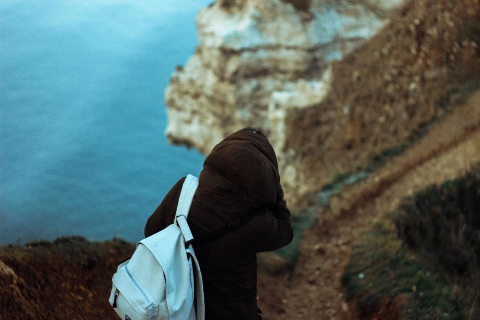 Free Image of Person Hiking Up Hill With Backpack 