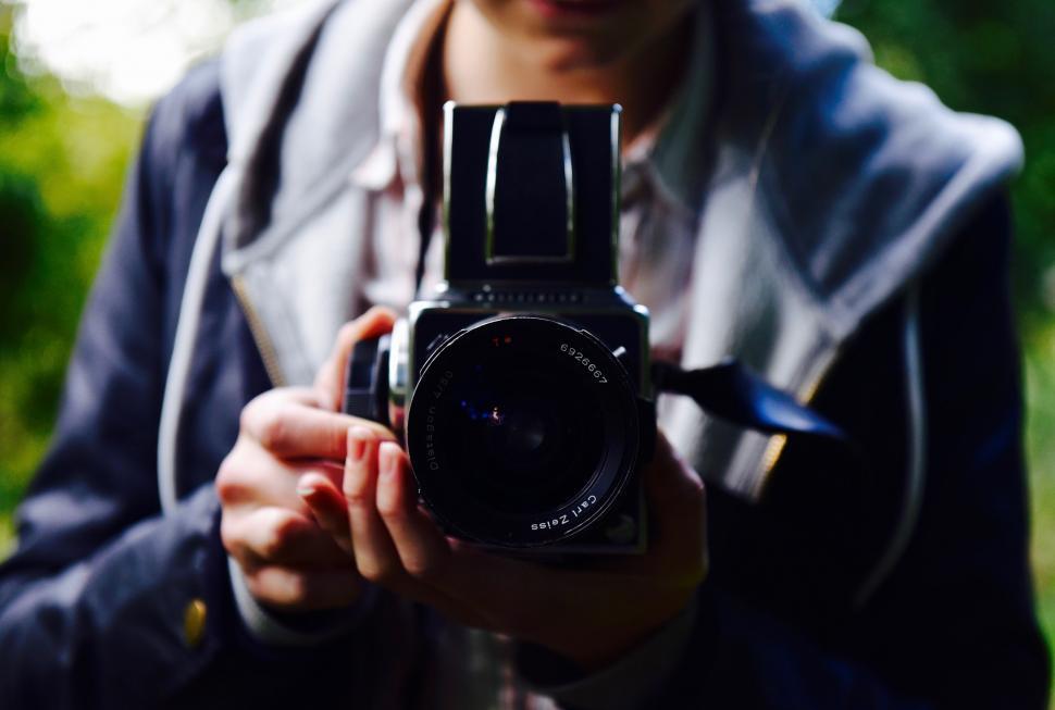 Free Image of Man Holding Camera in Hands 