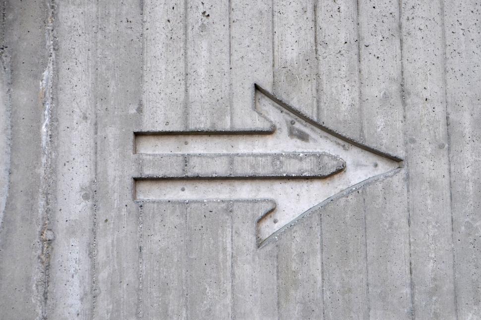 Free Image of Concrete Sign With Arrow Pointing Left 