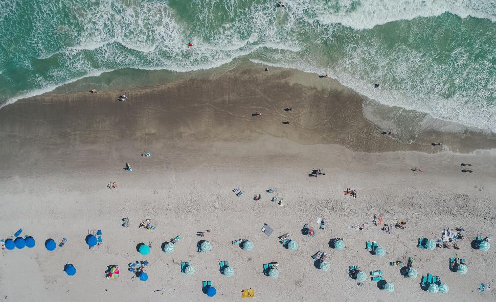 Free Image of Aerial View of a Beach With People and Umbrellas 