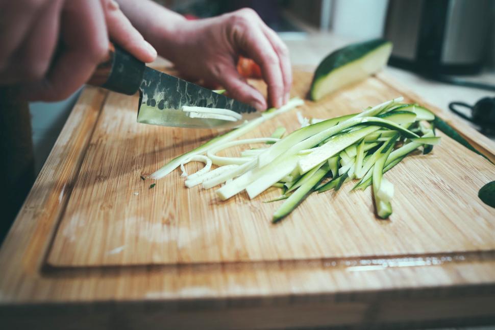 Free Image of Person Cutting Up Vegetables on Cutting Board 