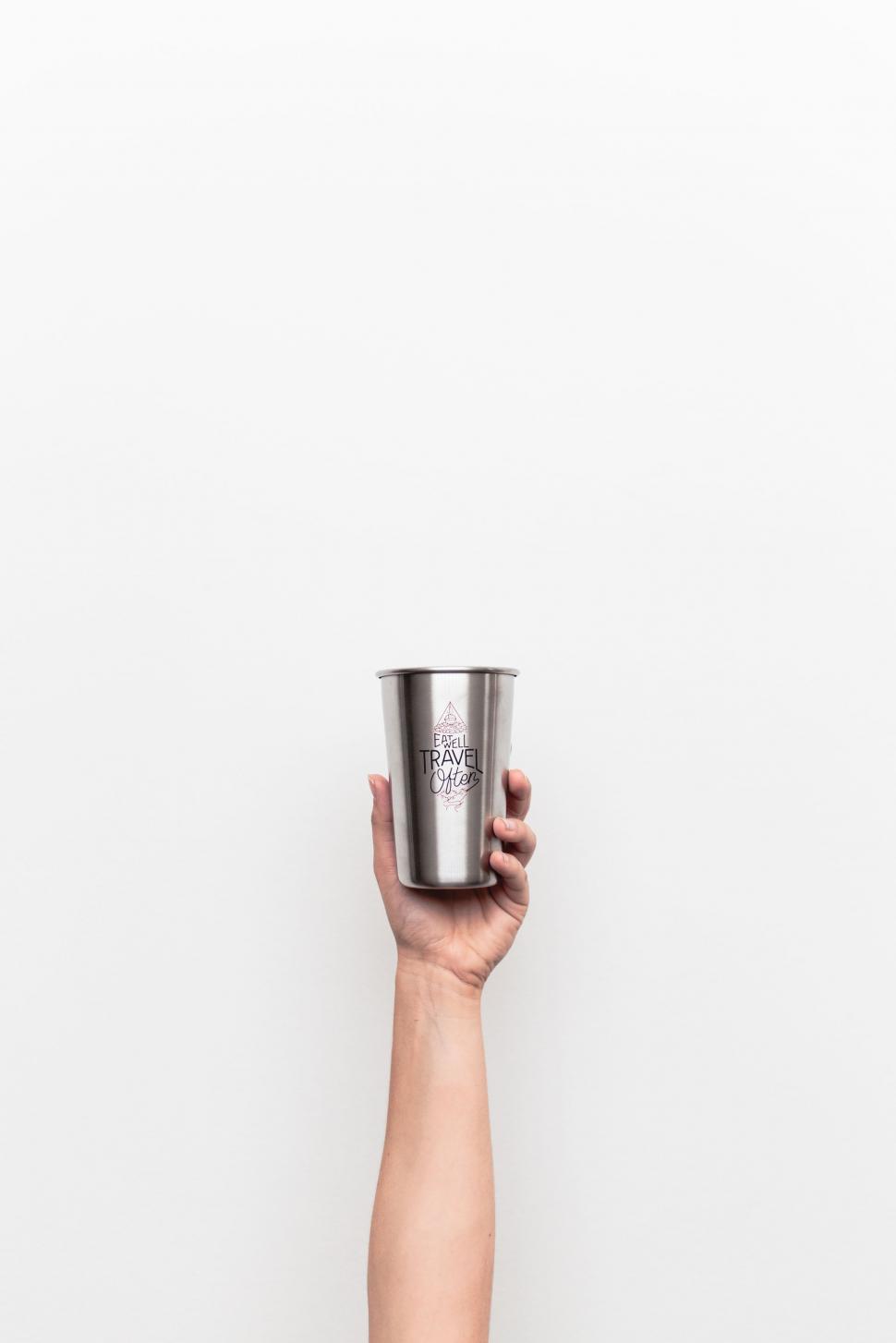 Free Image of Hand Holding Cup Up in the Air 