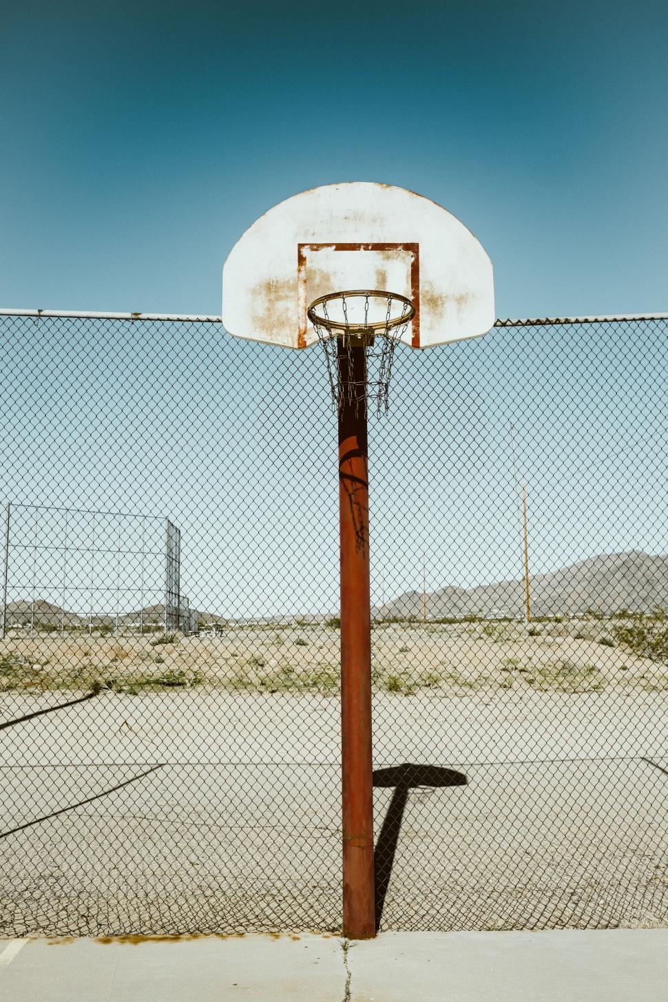Free Image of Basketball Hoop in the Middle of a Basketball Court 