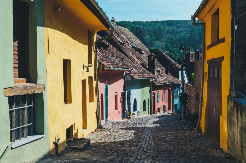 Free Image of Colorful Buildings Along Cobblestone Street 