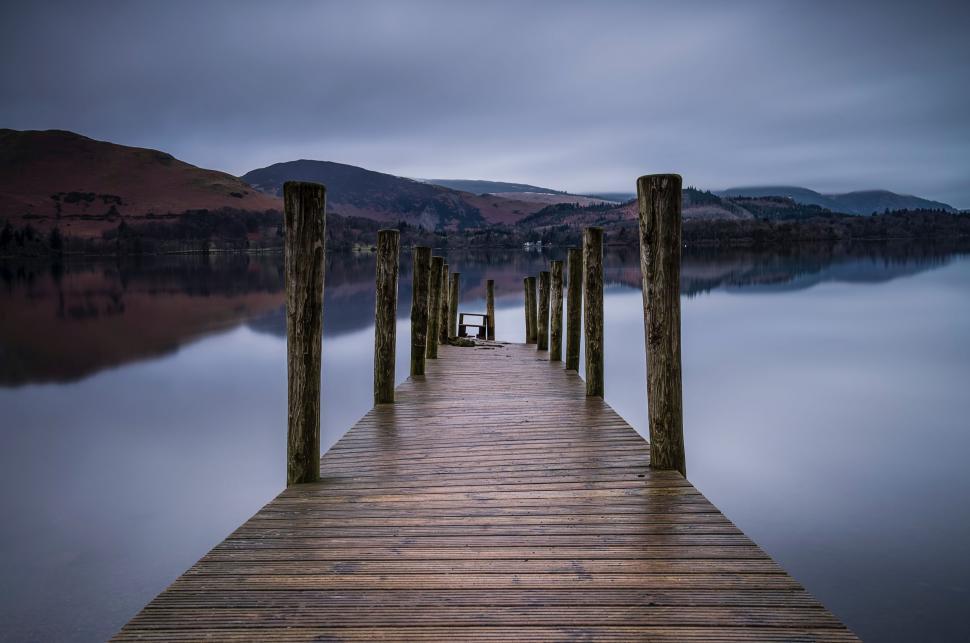 Free Image of Wooden Dock on Lake Under Cloudy Sky 