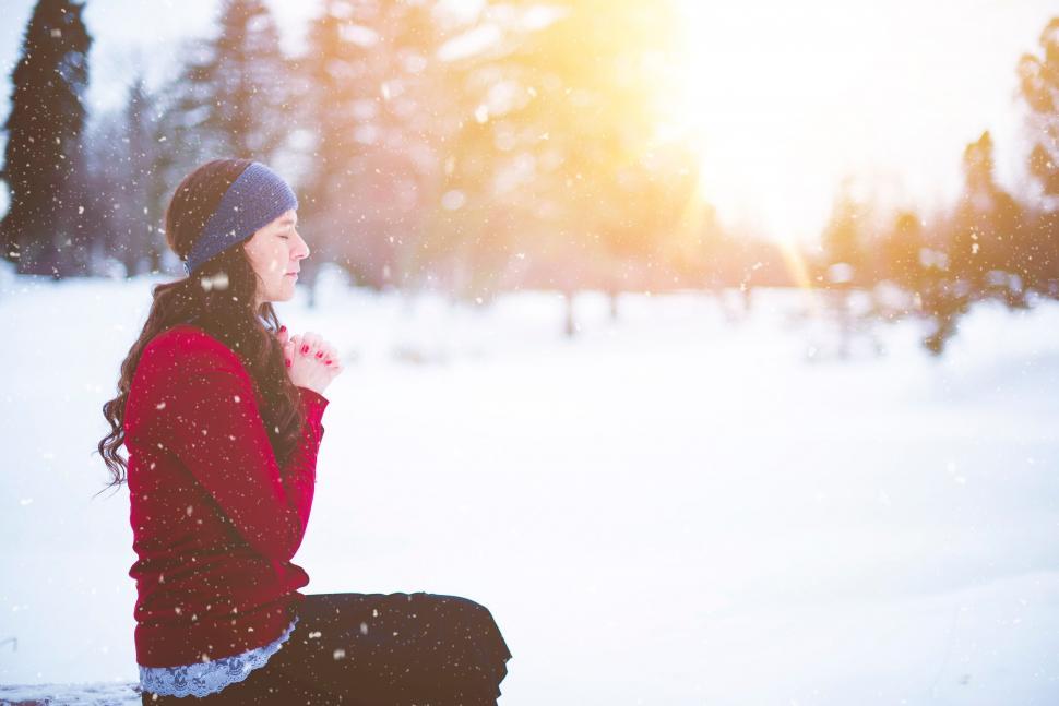 Free Image of Woman Sitting on Bench in Snow 