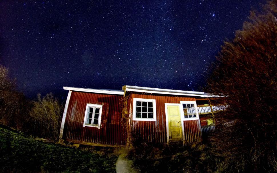 Free Image of Small Red House on Hill Under Night Sky 