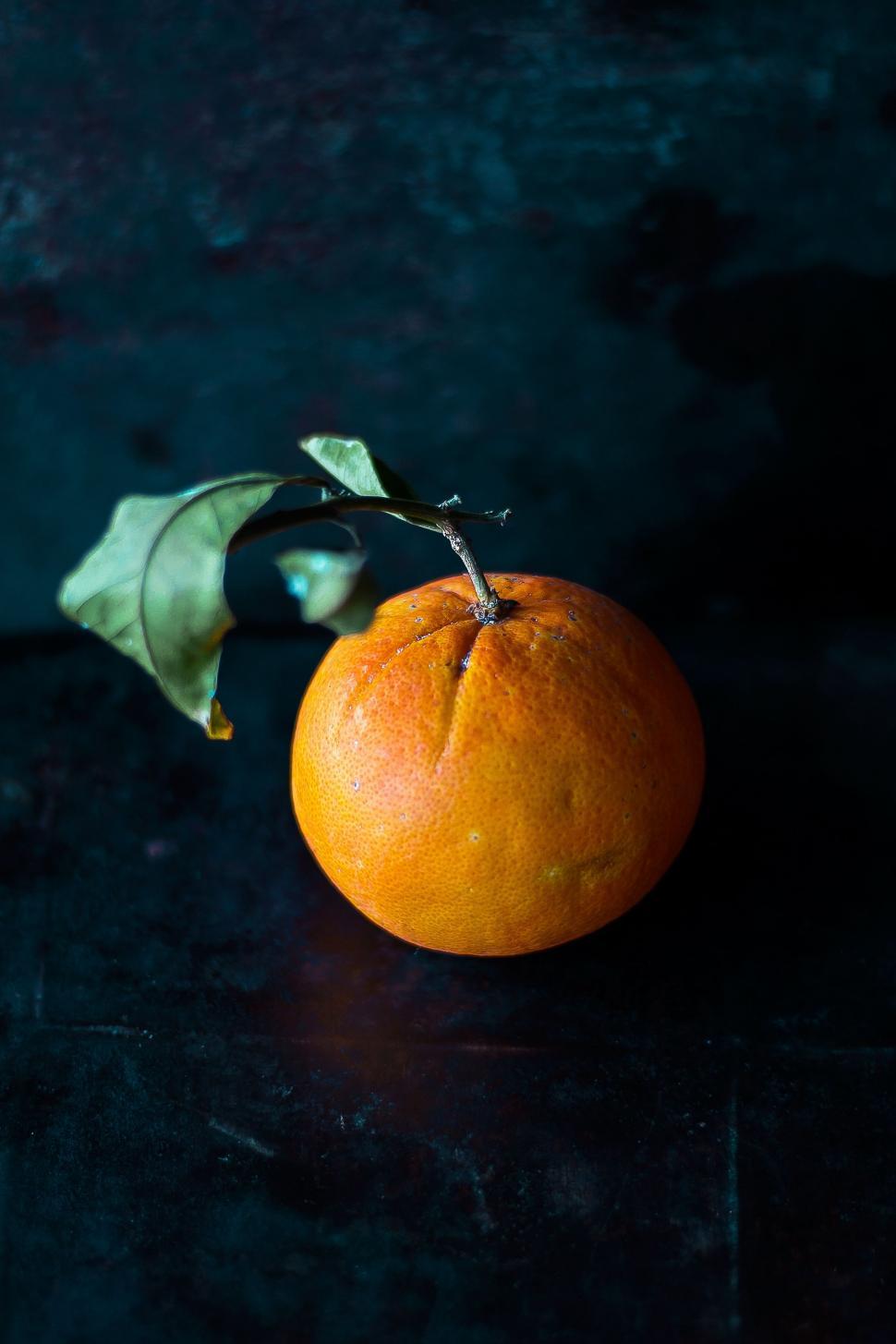 Free Image of Orange With Leaf on Table 