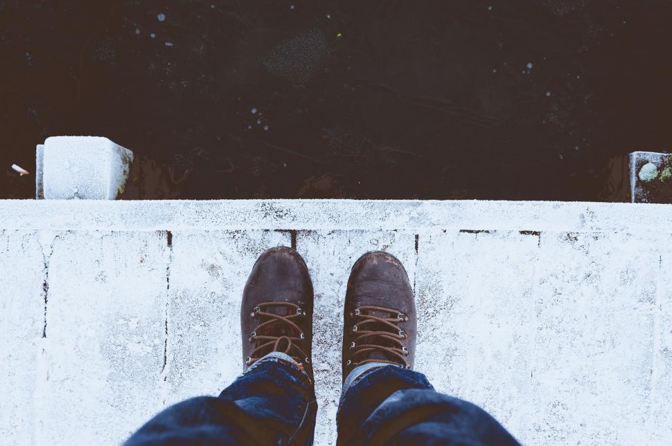 Free Image of Person Standing on Ledge With Feet Up 