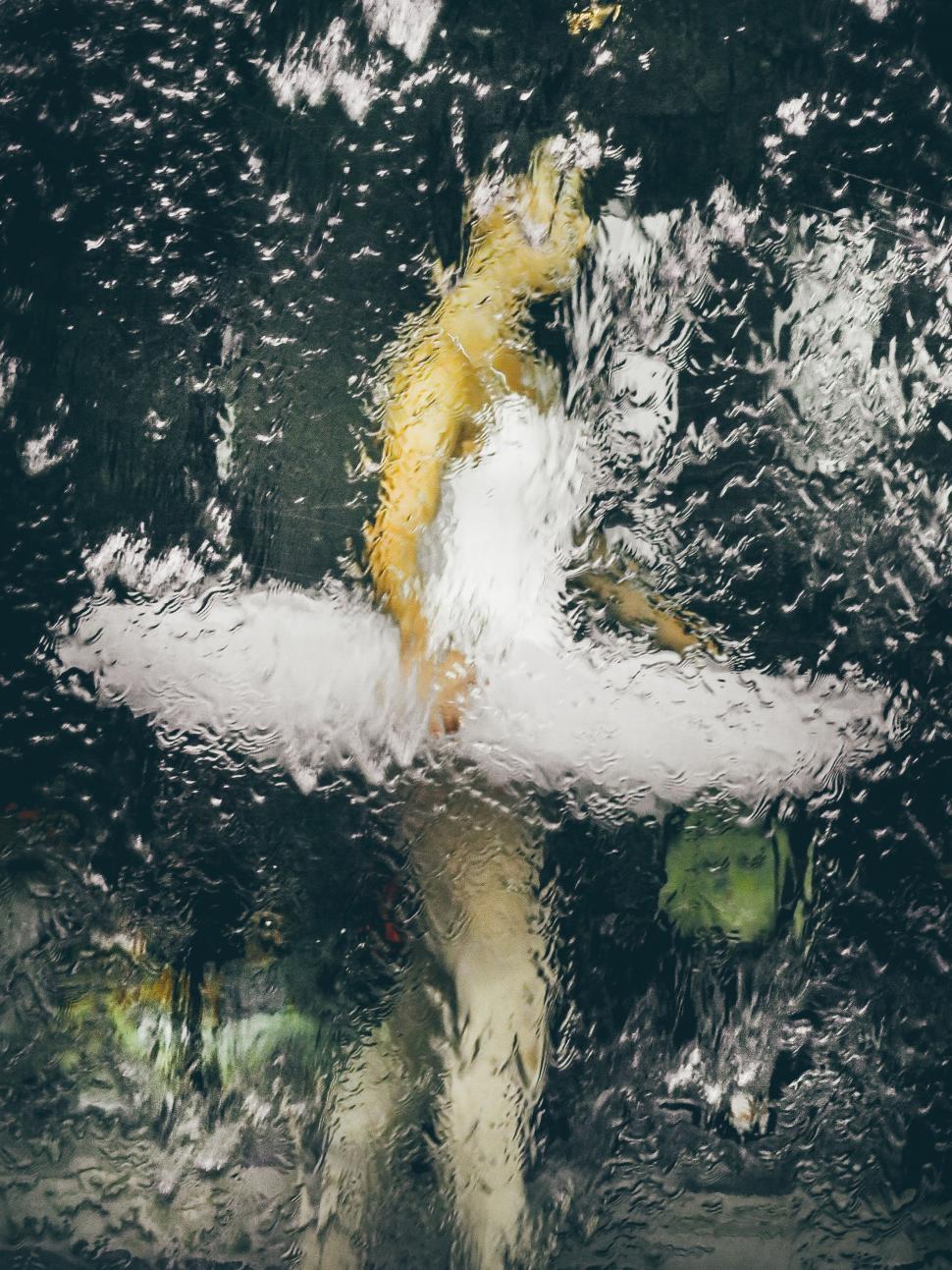 Free Image of Man Holding Surfboard in the Rain 