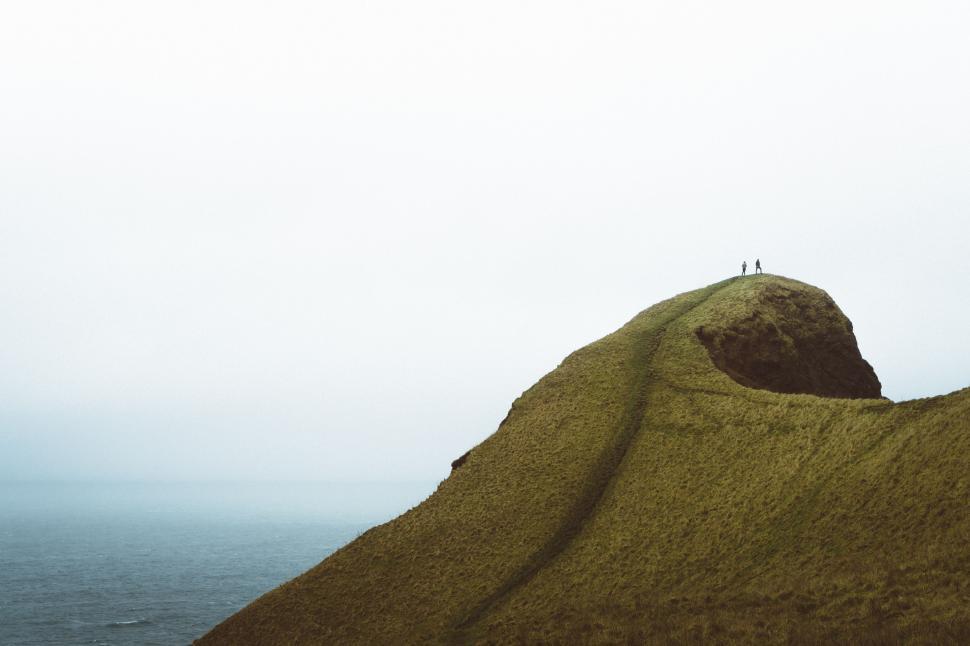 Free Image of Person Standing on Hill Next to Ocean 