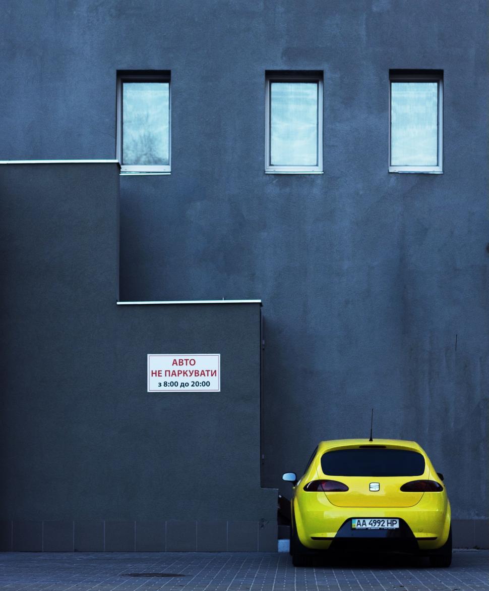 Free Image of Yellow Car Parked in Front of Building 