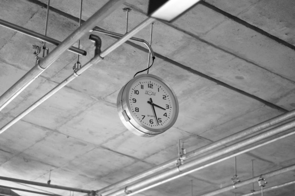 Free Image of Clock Hanging From Ceiling in Garage 
