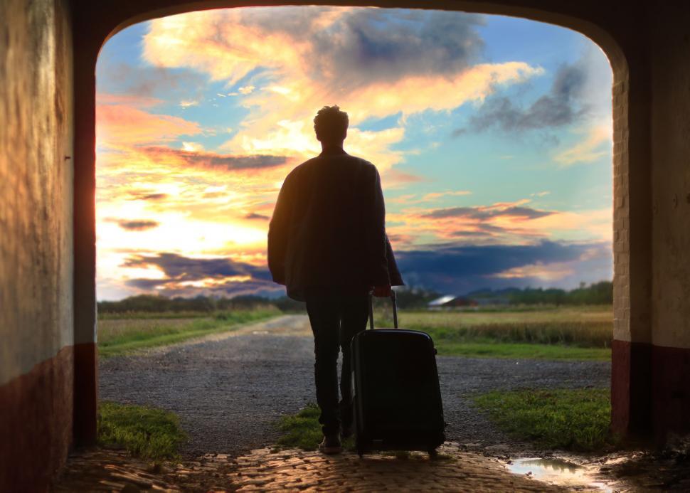 Free Image of Man Exiting Tunnel With Suitcase 