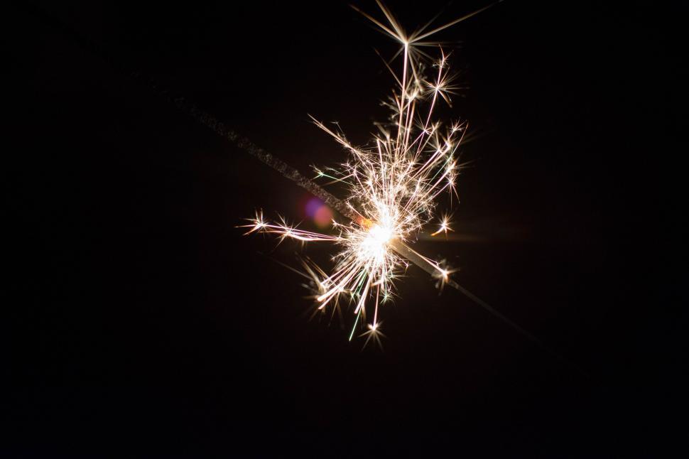 Free Image of Illuminated Sparkler in Dark Background 
