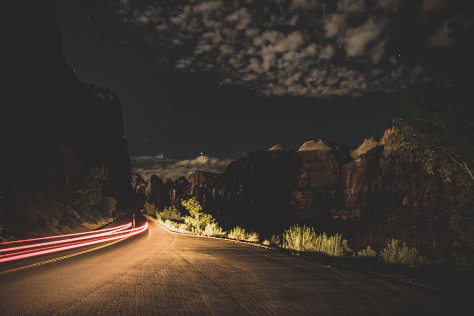 Free Image of Car Driving Down Road at Night 