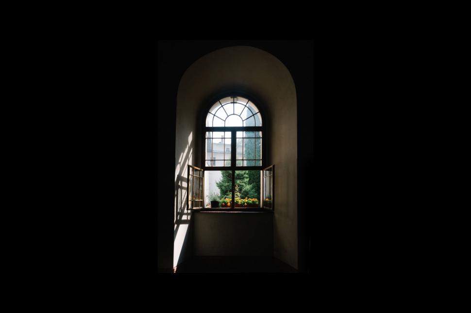 Free Image of Light Shining Through Window in Dark Room 