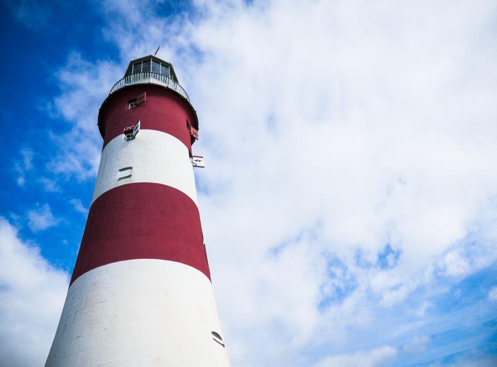 Free Image of Red and White Lighthouse Under Blue Sky 