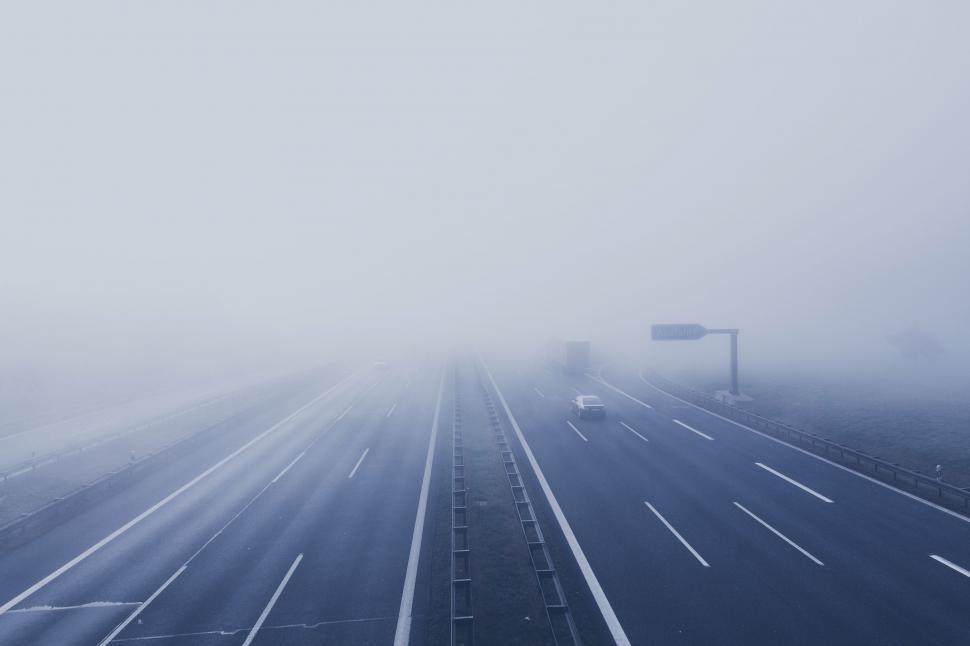 Free Image of Foggy Highway With Cars Driving 