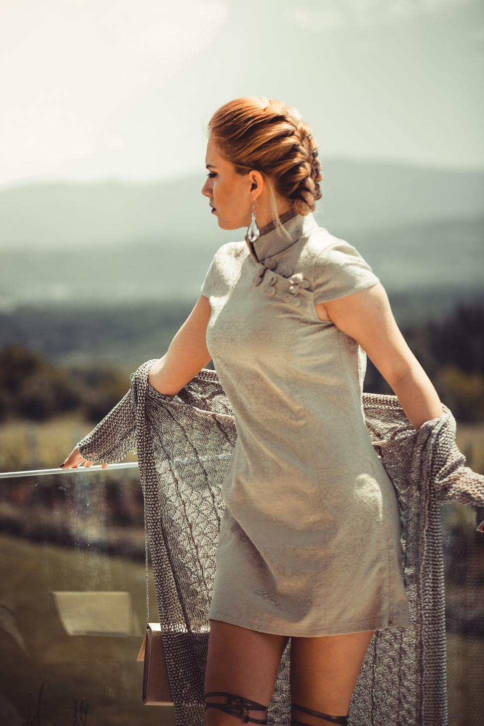 Free Image of Woman in Gray Dress Holding Scarf 