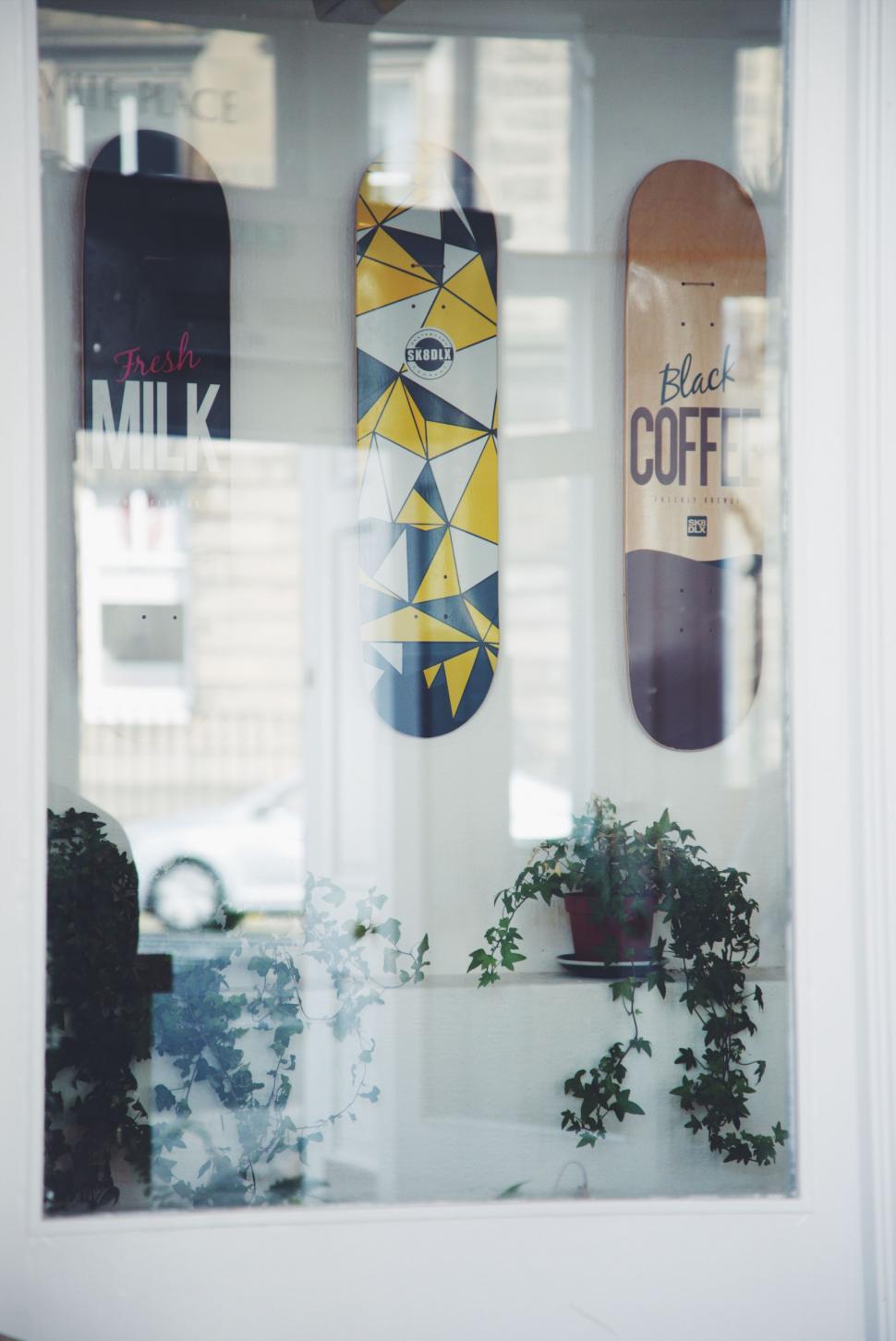 Free Image of Array of Skateboards on Display in a Window 