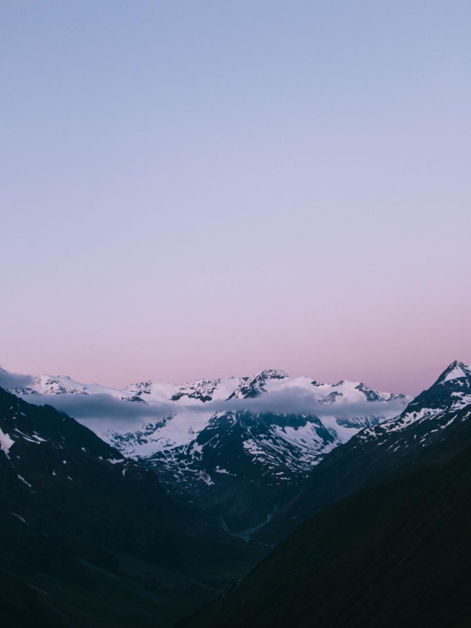 Free Image of Majestic Mountain Range Under a Pink Sky 
