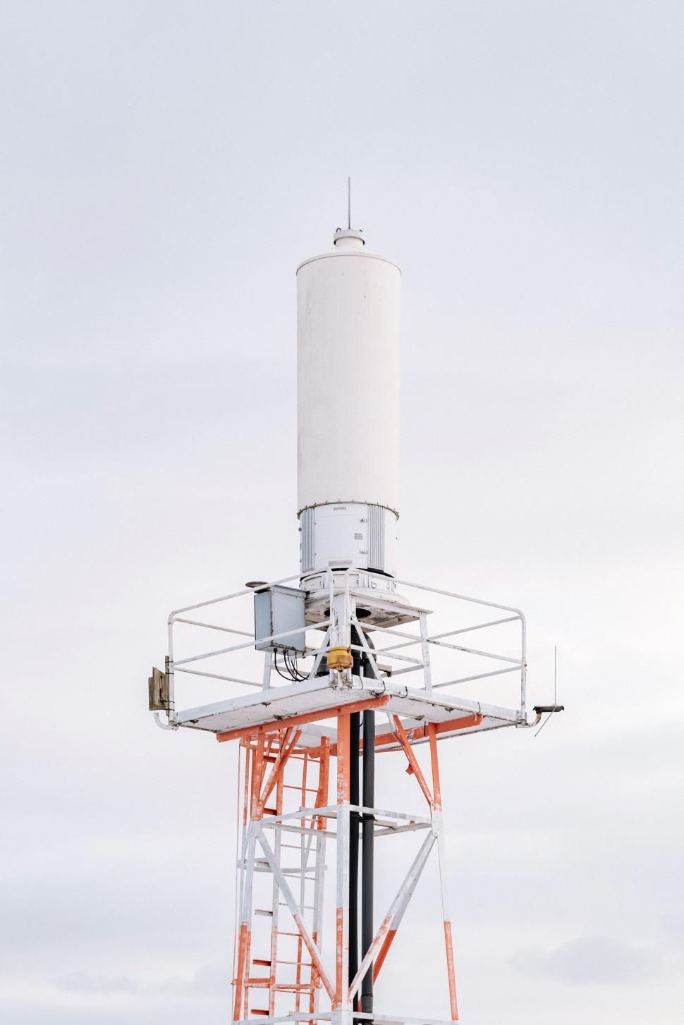 Free Image of White and Orange Tower Against Sky 