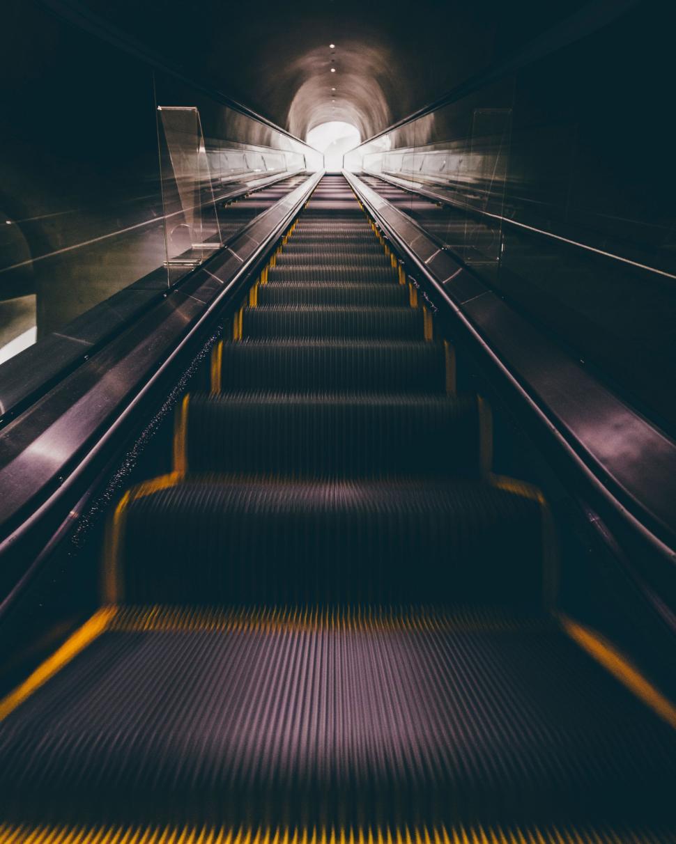 Free Image of The Escalator in a Subway Station With a Light at the End 